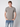 A young man with short light brown hair wears the PROJEK RAW Mens Liquid Cotton Short Sleeve T-shirt and blue jeans, standing against a light gray background with his hands in his pockets.