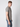 A young man with short light brown hair stands sideways, wearing the PROJEK RAW Mens Liquid Cotton Short Sleeve T-shirt and blue jeans, looking toward the camera against a plain light background.