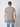 A man faces away from the camera in a PROJEK RAW Mens Liquid Cotton Short Sleeve T-shirt, plain light gray, paired with light blue jeans, made of super soft cotton, set against a plain white background.
