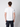 A man with short brown hair, seen from behind, wears a PROJEK RAW Mens Liquid Cotton Short Sleeve T-shirt and dark pants against a light gray background.