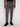 A person wears Projek Raw’s BASTIEN-GREY tailored-fit plaid drawstring pants with a black shirt and sneakers, standing against a plain white background.