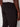 A person is shown from the waist down wearing Projek Raw’s ANTOINE-BLACK pants, featuring an elastic waistband and a single back pocket. Their right arm hangs relaxed at their side against a plain, light background.