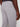 A person wears Projek Raws ANTOINE-SILVER light gray pants with an elastic waistband, back welt pocket, and side seam pocket, standing with one hand relaxed by their side.