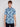A young man with short, light brown hair wears the BENJAMIN-BLUE palm tree print shirt by Projek Raw, made from 4-way stretch fabric, standing against a plain light background.