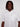 A person with medium-length dreadlocks models the ALEXANDER-WHITE wrinkle-resistant shirt by Projek Raw, standing against a white background and looking at the camera with a neutral expression.