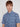 A young man with straight light brown hair wears the Projek Raw ARNAUD-BLUE short-sleeve button-up shirt with a geometric pattern, standing against a plain light background.