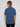 A person with light brown hair stands against a plain background, facing away from the camera, wearing the Projek Raw ADRIAN-BLUE short-sleeve travel shirt made from easy-to-pack fabric and black pants.