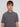 A young person with light brown hair and blue eyes wears the Projek Raw ADRIAN-GREY short-sleeve 4-way stretch shirt with a zippered chest pocket, standing against a plain white background and looking at the camera neutrally.
