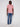 A person stands against a plain light background, wearing the Projek Raw BLAISE-RED modern casual short-sleeve shirt with blue jeans and white sneakers.