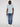 A man stands against a plain light background, wearing the Projek Raw BLAISE-AQUA modern casual cotton short-sleeve shirt with blue jeans and white sneakers. He faces forward with a neutral expression.