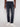A person wears Projek Raw JAXON-BLUE BLACK stretch denim athletic fit jeans with white sneakers, standing against a plain light background, shown from the waist down.