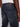 A close-up of a person wearing Projek Raw JAXON-BLUE BLACK athletic fit jeans and a white shirt, highlighting the back pocket detail and black waistband label.