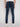 A person wearing Projek Raw KEVIN-INK BLUE denim pants and white sneakers stands with their back to the camera against a plain white background.