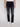 A person wearing Projek Raw HENRI-BLUE BLACK RINSE jeans and white sneakers stands against a plain light background, with only the lower half of the body visible.