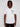 A man with medium-length dreadlocks wears the BASILE-WHITE by Projek Raw, a white short-sleeve knit top featuring black graphic text and geometric designs. He stands facing forward against a plain light gray background.