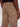A person is shown from the waist down wearing Projek Raw EDGAR-CASHEW light brown cargo pants with visible back pocket stitching, paired with a black shirt and their right hand resting by their side.