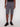 A person wears Projek Raws ISMAËL-GREY knee-length cargo shorts with side pockets, a black shirt, and black sneakers, standing against a plain white background.