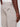 Close-up of a person wearing Projek Raws ISMAËL-MUSHROOM light beige cargo pants featuring zipper and flap pockets, paired with a white tucked-in shirt.