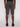 A person wearing Projek Raw PAULIN-OLIVE cargo shorts and black slip-on shoes stands with their back to the camera against a plain white background.
