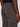 A close-up of a person wearing Projek Raw PAULIN-OLIVE cargo pants highlights the waistband, back pocket, side cargo pocket, and part of their hand at their side.