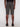 Back view of a person wearing Projek Raw DESMOND-OLIVE cargo shorts with multiple pockets and black shoes, standing against a plain white background.