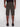 A person stands with their back to the camera, modeling the Projek Raw JACOBI-OLIVE cargo shorts, which feature multiple rear pockets. Black belt and shoes complete the look against a plain light background.