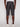A person is shown from the back wearing Projek Raw’s DARIAN-BLACK charcoal gray knee-length cargo shorts, a white shirt, and white sneakers against a plain light background.