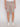 A person wearing Projek Raws SYLVAIN-TABAC light brown drawstring shorts stands in front of a plain light background, paired with a white shirt and white sneakers. The image is cropped just below the shoulders.