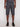 Wearing the Projek Raw REMINGTON-CHARCOAL set—grey t-shirt, dark grey knee-length shorts, and black sneakers—a person stands facing forward against a plain light background with arms relaxed at their sides.