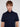 A young man with light brown hair and blue eyes wears the ANDRÉ-NAVY short-sleeve button-up shirt by Projek Raw, standing against a plain light background and looking directly at the camera with a neutral expression.