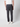A person stands facing away, wearing a white shirt, PROJEK RAW Men’s Stretch Bungee Cargo Jogger in dark gray with elastic waistband and cuffs, and white sneakers, against a plain light background.