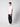 A young man with short curly hair and a neutral expression stands sideways against a plain light background, wearing PROJEK RAW Men’s Stretch Bungee Cargo Jogger, a fitted white t-shirt, and white sneakers.