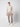 A young man stands against a plain light background, wearing a beige long-sleeve sweater, PROJEK RAW Men’s Plaid Bungee Drawstring Pant, and white sneakers. He faces forward with a neutral expression and relaxed posture.