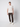 A young man stands against a plain light background, wearing a light beige short-sleeve t-shirt, PROJEK RAW Men’s Canvas Bungee Pull-on Cargo Jogger, and white sneakers, looking at the camera with a neutral expression.