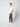 A young man with short light brown hair stands in profile against a white background, wearing a white t-shirt, PROJEK RAW Men’s Canvas Bungee Pull-on Cargo Jogger, and white sneakers, looking towards the camera.