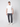 A man stands against a plain light background wearing a white t-shirt, PROJEK RAW Men’s Canvas Bungee Pull-on Cargo Jogger in charcoal gray, and white sneakers. He faces forward with a neutral expression and relaxed posture.