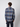 A person with short curly hair stands with their back to the camera, wearing a PROJEK RAW Men’s Long Sleeve Plaid Button-up Shirt and dark pants against a plain light background—perfect for casual style.