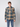A young person wearing a PROJEK RAW Mens Long Sleeve Plaid Button-up Shirt in beige, blue, and black with blue jeans stands against a plain light background, looking directly at the camera with a neutral expression.