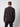 A man with short brown hair faces away from the camera, wearing a black PROJEK RAW Mens Long Sleeve Henley Top and black pants, set against a plain light background.