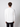 A man with curly brown hair is seen from behind wearing a PROJEK RAW Mens Long Sleeve Henley Top in white and black pants, standing against a plain light gray background.