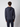 A person with short, curly brown hair is seen from behind wearing a PROJEK RAW Mens Long Sleeve Hoodie with Kangaroo Pocket and matching pants against a plain light gray background.