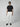 A person wearing sunglasses, a black t-shirt, PROJEK RAW Mens Solid Bungee Loose Chino Pant in white, and black shoes stands against a plain light gray background—ideal for casual style.