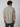 A man with short brown hair is seen from behind wearing the PROJEK RAW Mens Short Sleeve Textured 4-Way Stretch Shirt in light gray and dark pants, standing against a plain light background.
