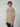A young man with short brown hair wears a PROJEK RAW Mens Short Sleeve Graphic T-Shirt, which features a chest pocket and subtle large lettering, standing against a plain light gray background.