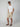 A man wears PROJEK RAW MENS CARGO SHORT, sunglasses, and a white t-shirt—perfect summer staples—while standing with hands in pockets against a plain light gray background.