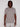 A man with medium-length dreadlocks wears the Projek Raw AARON-GREY short-sleeve polo shirt and light pants, standing facing forward against a plain white background.