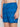 A person wearing BRYSON-BLUE swim trunks from Projek Raw. Only their midsection and upper thighs are visible. The trunks have a blue geometric pattern, a drawstring waist, and a small arrow logo near the hem.