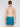 A man with short brown hair and black sunglasses models the Projek Raw BRUNO-TURQUOISE swim trunks, featuring a palm tree pattern. He stands against a white background, facing forward with a neutral expression.
