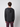 A person with short curly hair, seen from behind, wears the PROJEK RAW Mens Long Sleeve Hoodie with Kangaroo Pocket and maroon pants, standing against a plain light gray background.