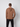 A man faces away from the camera wearing the PROJEK RAW Mens Long Sleeve Hoodie with Kangaroo Pocket and black pants, set against a plain light gray background.